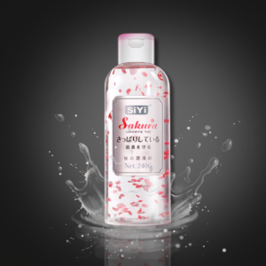 Personal lubricant bottle with pink floral design on a dark background