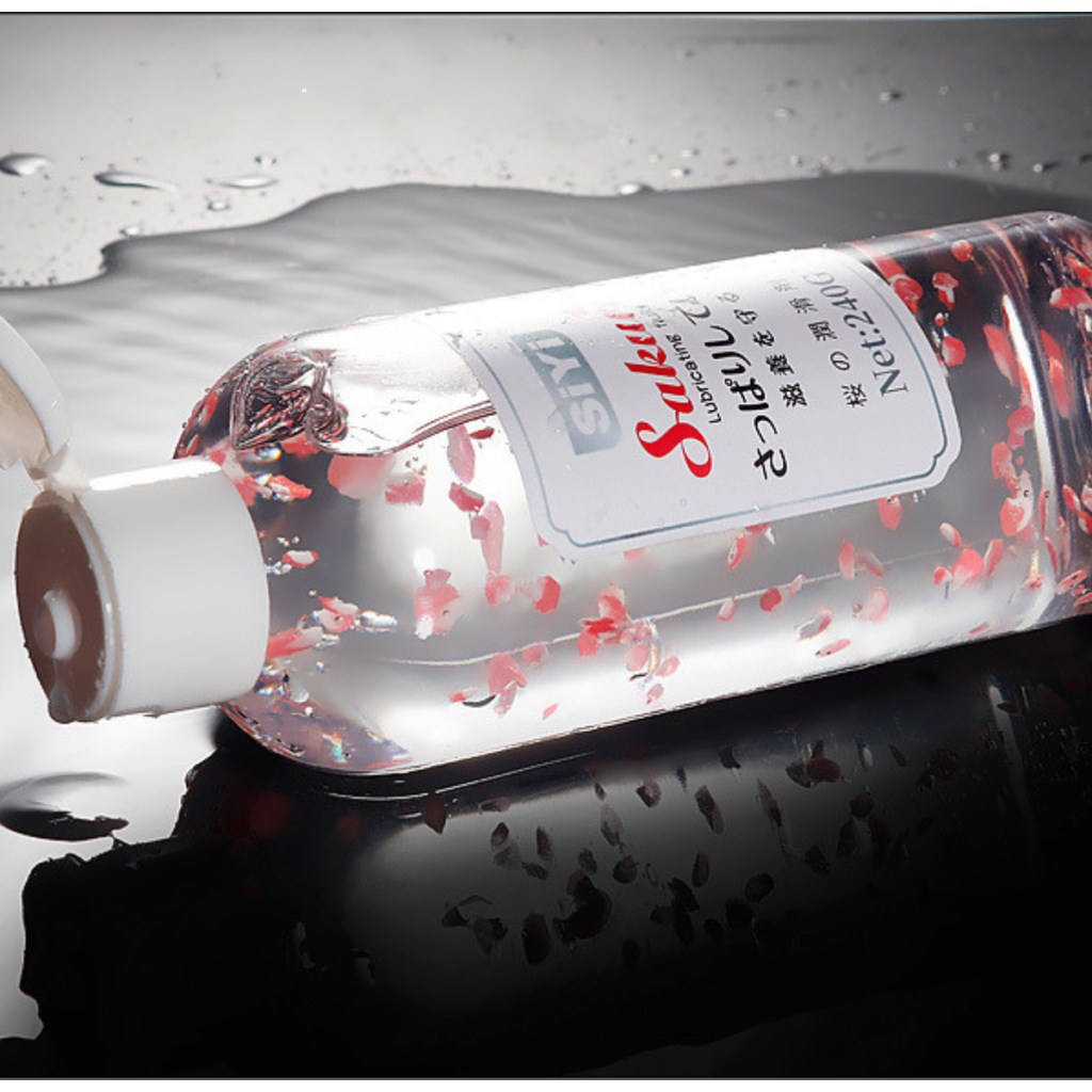 Personal lubricant bottle shown horizontally with water droplets