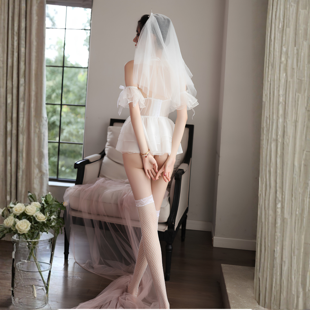 Rear view of model wearing white bridal lingerie with veil